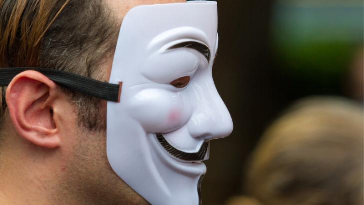 person weraing anonymous mask 